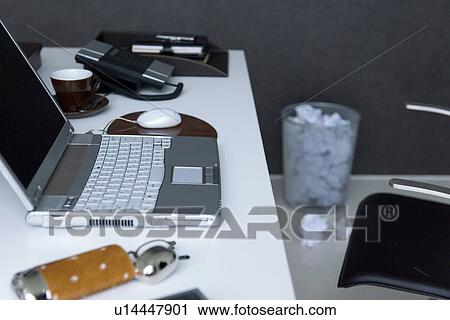 Laptop on desk with wastepaper basket full of crumpled paper View Large Photo Image Stock Image - Laptop on desk with wastepaper basket full of crumpled paper. Fotosearch