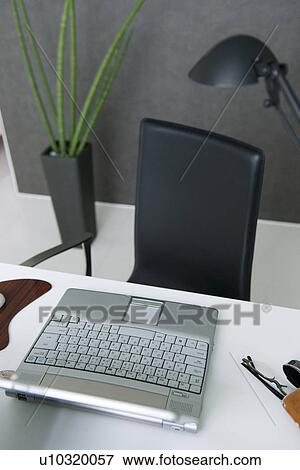 Laptop on office desk View Large Photo Image Stock Photo - Laptop on office desk. Fotosearch