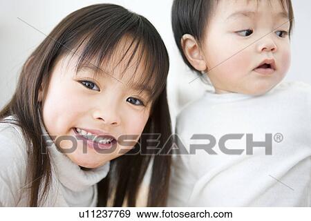 Little girl and her baby brother View Large Photo Image Stock Photo - Little girl and her baby brother. Fotosearch
