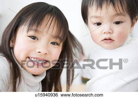 Stock Photograph - Little girl and her baby brother. Fotosearch