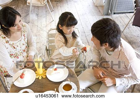 Little girl feeding father some of her cake at a cafe View Large Photo Image Stock Image - Little girl feeding father some of her cake at a cafe. Fotosearch