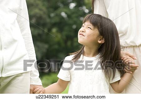 Little girl walking with her parents hand in hand View Large Photo Image Stock Image - Little girl walking with her parents hand in hand. Fotosearch