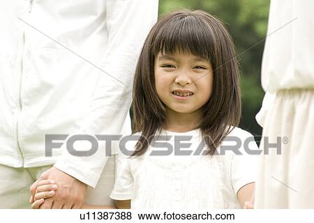 Little girl walking with her parents hand in hand View Large Photo Image Stock Photo - Little girl walking with her parents hand in hand. Fotosearch
