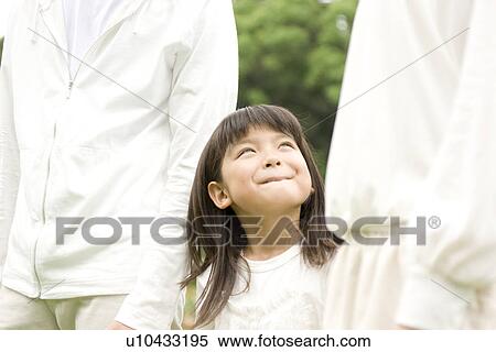 Little girl walking with her parents hand in hand View Large Photo Image Stock Photography - Little girl walking with her parents hand in hand. Fotosearch