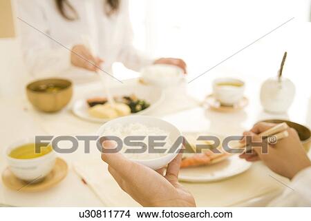 Man and woman sitting eating meal View Large Photo Image Picture - Man and woman sitting eating meal. Fotosearch