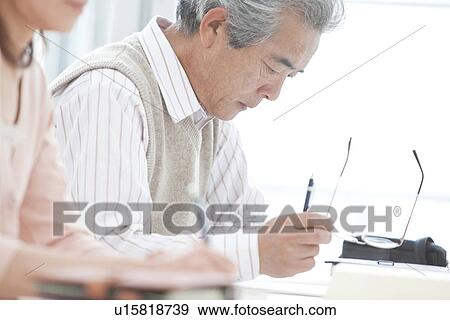 Stock Photo - Man and woman studying. Fotosearch