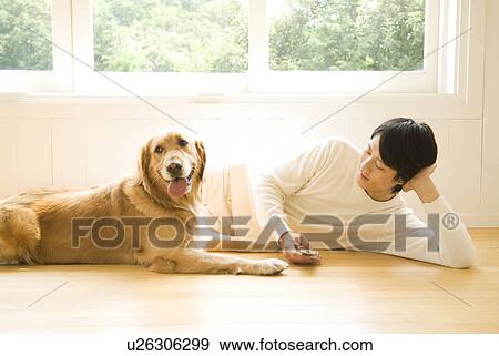 Man lying on the floor with his dog View Large Photo Image Stock Photo - Man lying on the floor with his dog. Fotosearch