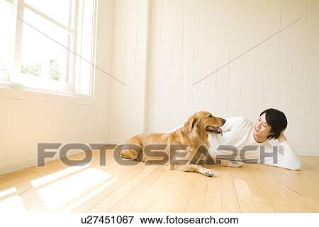 Man lying on the floor with his dog View Large Photo Image Stock Photo - Man lying on the floor with his dog. Fotosearch