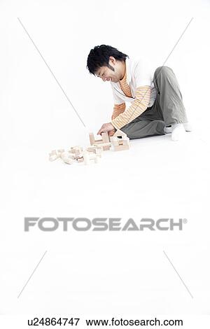 Man playing with toy blocks View Large Photo Image Stock Photo - Man playing with toy blocks. Fotosearch