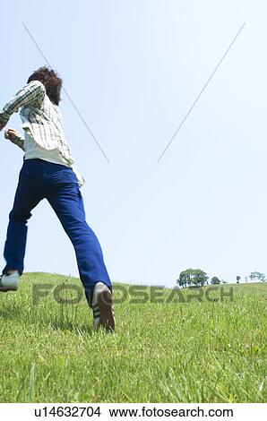 Man running on grass View Large Photo Image Picture - Man running on grass. Fotosearch