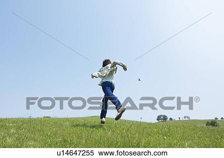 Man running on grass View Large Photo Image Stock Photography - Man running on grass. Fotosearch