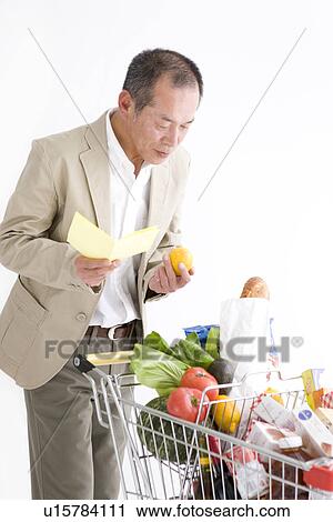 Stock Image - Man shopping for groceries. Fotosearch