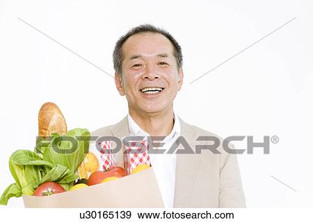 Stock Photo - Man shopping for groceries. Fotosearch