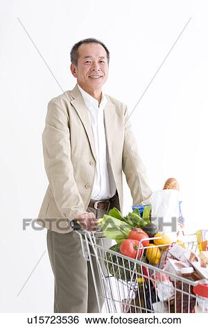 Stock Photograph - Man shopping for groceries. Fotosearch