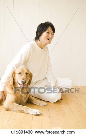 Man sitting on the floor with his dog View Large Photo Image Stock Image - Man sitting on the floor with his dog. Fotosearch