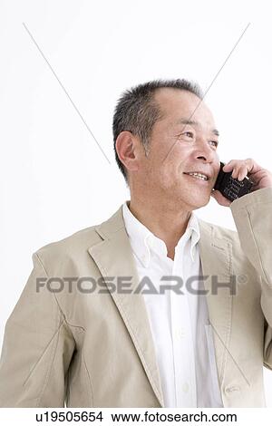 Man talking on his mobile phone View Large Photo Image Picture - Man talking on his mobile phone. Fotosearch