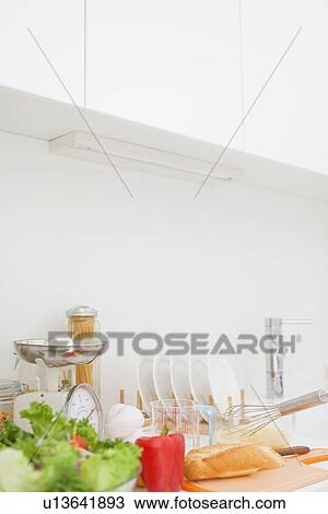 Stock Image - Meal being prepared on kitchen bench. Fotosearch