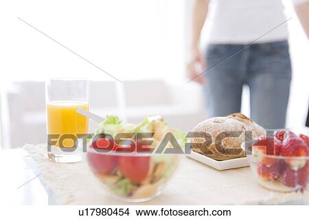 Picture - Meal of salad, strawberries and bread rolls and a glass of juice. Fotosearch