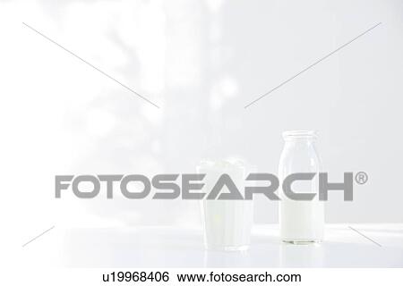 Milk bottle and a glass View Large Photo Image Stock Photograph - Milk bottle and a glass. Fotosearch