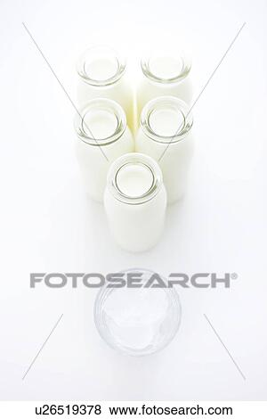 Stock Photo - Milk bottles and a glass. Fotosearch