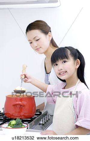 Mother and daughter cooking soup View Large Photo Image Stock Image - Mother and daughter cooking soup. Fotosearch