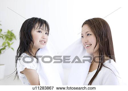 Mother and daughter helping to dry each others hair View Large Photo Image Stock Photo - Mother and daughter helping to dry each others hair. Fotosearch