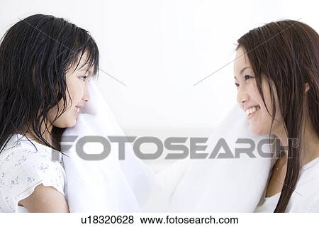 Mother and daughter helping to dry each others hair View Large Photo Image Stock Photo - Mother and daughter helping to dry each others hair. Fotosearch