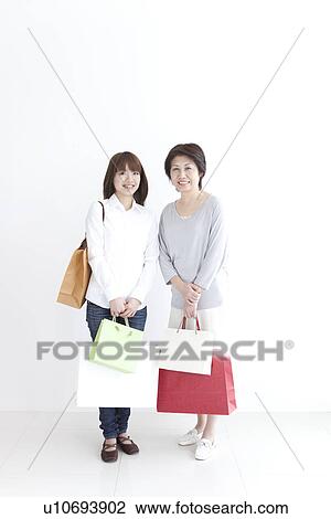 Mother and daughter holding shopping bags View Large Photo Image Stock Image - Mother and daughter holding shopping bags. Fotosearch