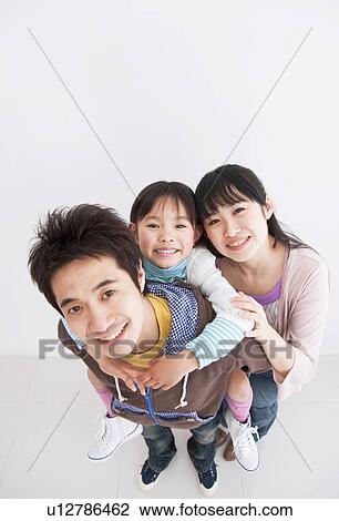 Mother, father and daughter getting a piggyback View Large Photo Image Stock Image - Mother, father and daughter getting a piggyback. Fotosearch