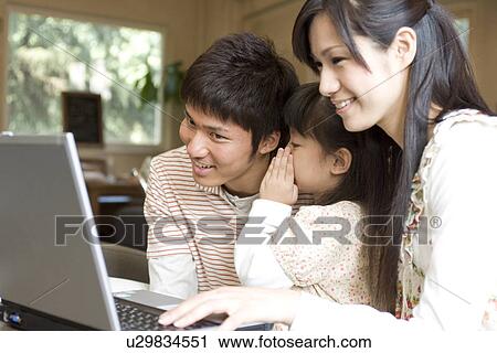 Mother, father and daughter using laptop at a cafe View Large Photo Image Stock Image - Mother, father and daughter using laptop at a cafe. Fotosearch