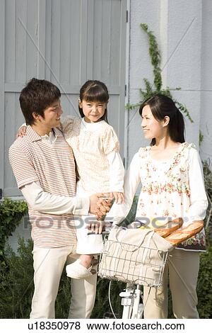 Mother, father and daughter walking with groceries in bicycle basket View Large Photo Image Stock Photo - Mother, father and daughter walking with groceries in bicycle basket. Fotosearch