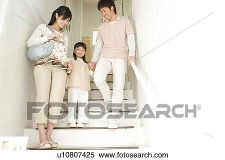 Mother, father and daughter walking down staircase View Large Photo Image Stock Photography - Mother, father and daughter walking down staircase. Fotosearch