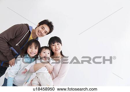 Stock Image - Mother, father, daughter and baby boy. Fotosearch