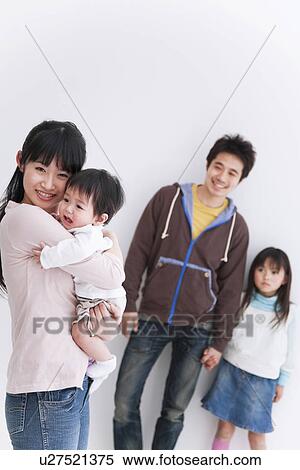 Stock Photography - Mother, father, daughter and baby boy. Fotosearch