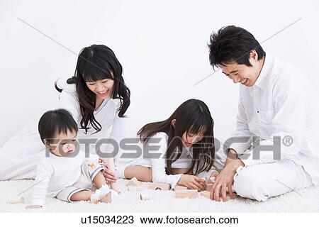 Mother, father daughter and baby son playing with blocks on a rug View Large Photo Image Stock Image - Mother, father daughter and baby son playing with blocks on a rug. Fotosearch
