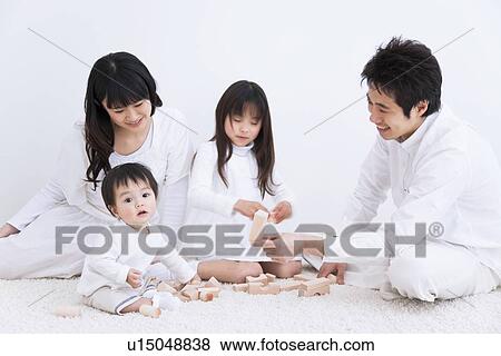Mother, father daughter and baby son playing with blocks on a rug View Large Photo Image Stock Photo - Mother, father daughter and baby son playing with blocks on a rug. Fotosearch