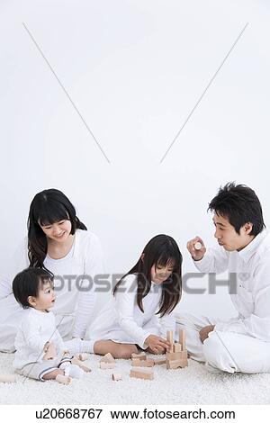 Mother, father daughter and baby son playing with blocks on a rug View Large Photo Image Stock Photo - Mother, father daughter and baby son playing with blocks on a rug. Fotosearch