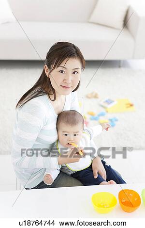 Mother feeding her baby View Large Photo Image Picture - Mother feeding her baby. Fotosearch