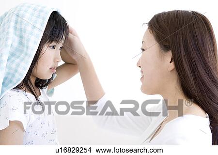 Picture - Mother helping to dry daughter's hair with a towel. Fotosearch