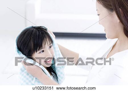 Mother helping to dry daughter's hair with a towel View Large Photo Image Stock Image - Mother helping to dry daughter's hair with a towel. Fotosearch