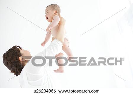 Mother holding up baby boy View Large Photo Image Stock Photography - Mother holding up baby boy. Fotosearch