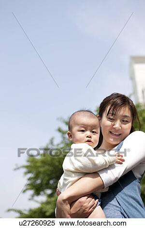 Stock Photography - Mother hugging her baby. Fotosearch