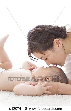 Stock Photo - Mother kissing baby. Fotosearch