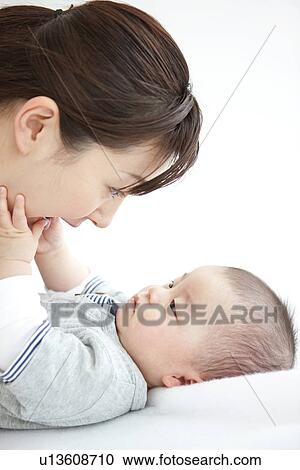 Mother playing with her baby View Large Photo Image Stock Image - Mother playing with her baby. Fotosearch