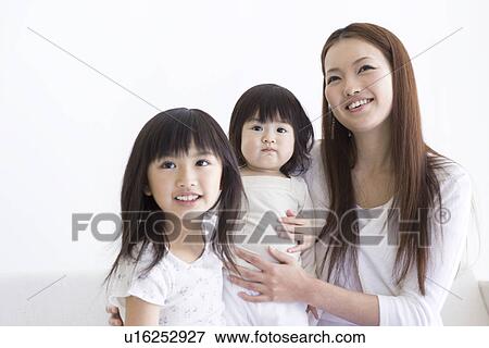 Mother sitting with her two daughters View Large Photo Image Stock Photo - Mother sitting with her two daughters. Fotosearch
