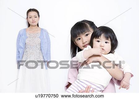 Stock Image - Mother with two daughters. Fotosearch