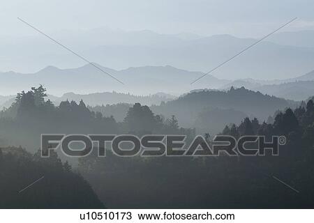 Stock Image - Mountain range surrounded by fog. Fotosearch