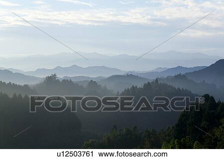 Stock Image - Mountain range surrounded by fog. Fotosearch