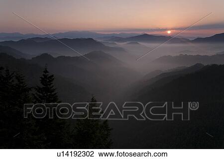 Mountain range surrounded by fog View Large Photo Image Stock Image - Mountain range surrounded by fog. Fotosearch