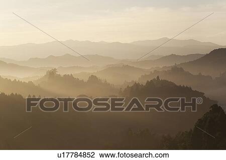 Stock Image - Mountain range surrounded by fog. Fotosearch